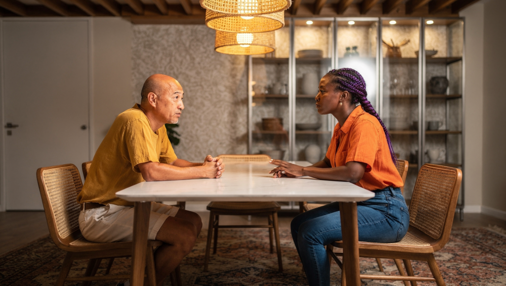 Cross-cultural Christian couple discussing marriage privacy and boundaries with parents